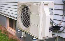 Exterior of home with energy efficient heat pump