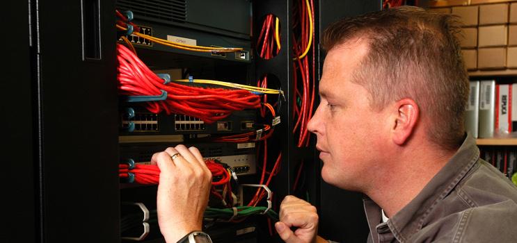 technician working on inside of computer