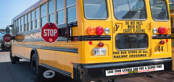 school bus with amber and red lights flashing