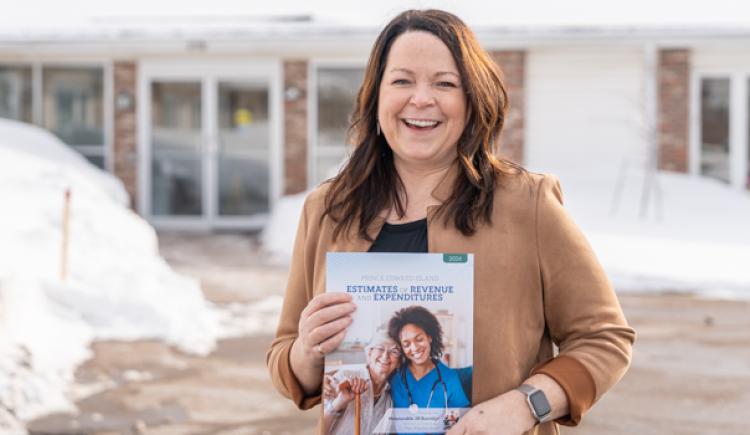 Minister of Finance Jill Burridge holding a copy of the Provincial Operating Budget