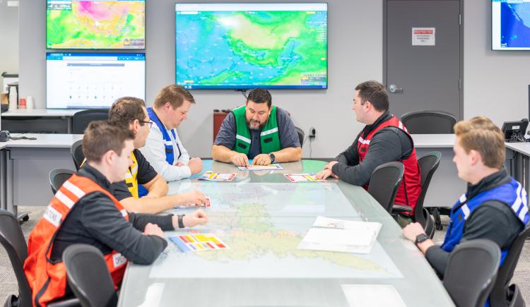 Members of Emergency Measures Organization around planning table