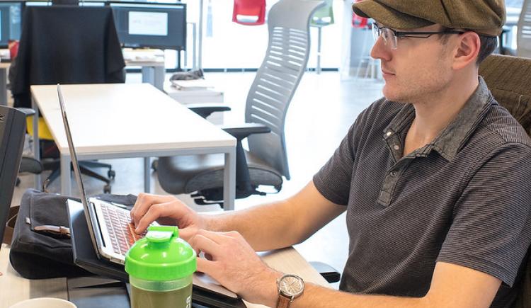 man working on a computer in a shared office space